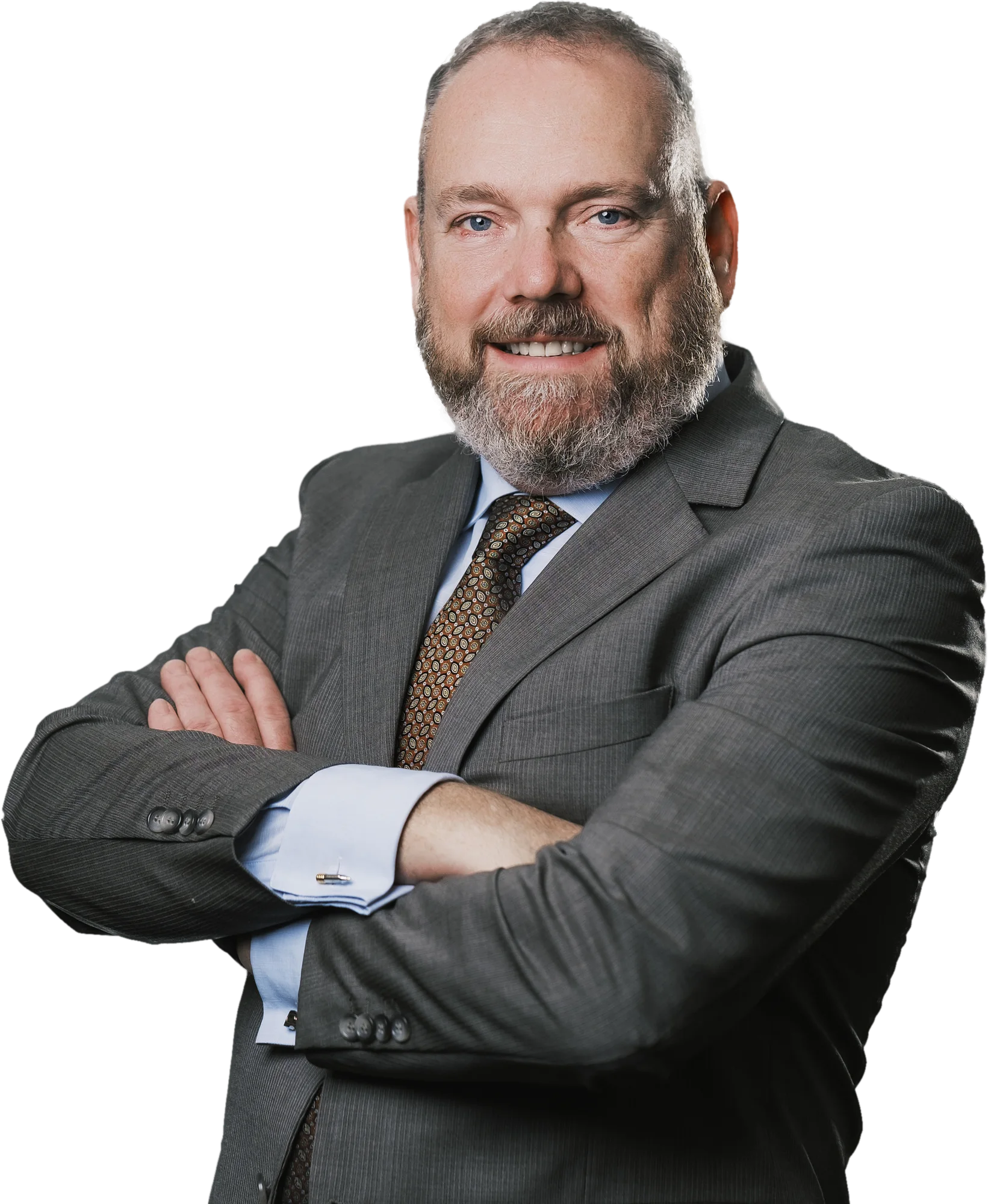 Neil Gannon smiling, arms crossed, in a charcoal suit